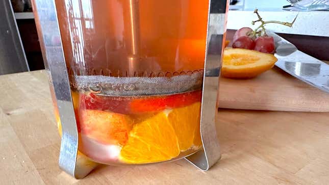 “Stir” the sangria by plunging once or twice. 